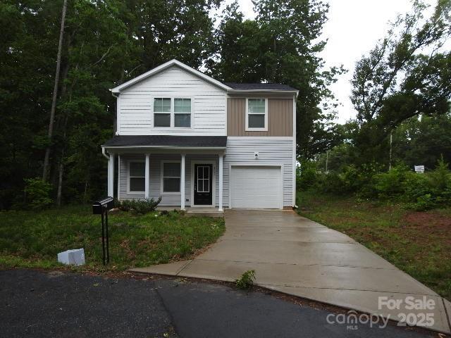 103 Spring Dr, Salisbury, NC 28144 - traditional-style home with concrete driveway, covered porch, and a garage