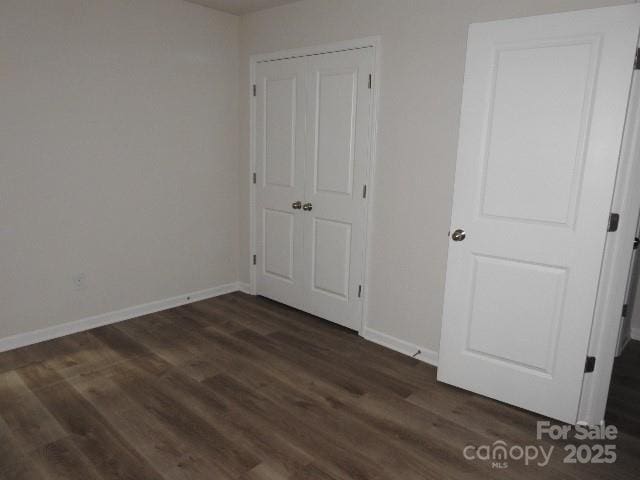 103 Spring Dr, Salisbury, NC 28144 - unfurnished bedroom featuring baseboards and dark wood-style flooring