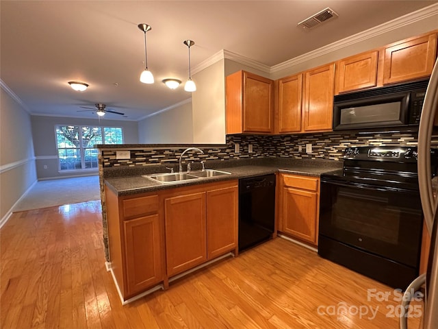 5236 Hilltop Rd, Jamestown, NC 27282 - kitchen featuring black appliances, ornamental molding, a peninsula, dark countertops, and a ceiling fan