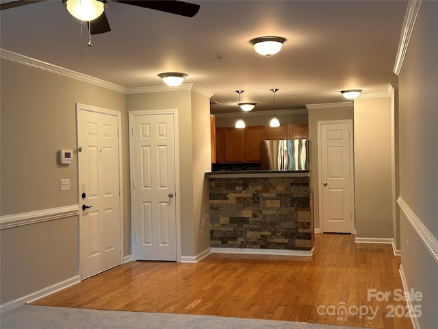 5236 Hilltop Rd, Jamestown, NC 27282 - kitchen featuring freestanding refrigerator, brown cabinets, ceiling fan, wood finished floors, and ornamental molding