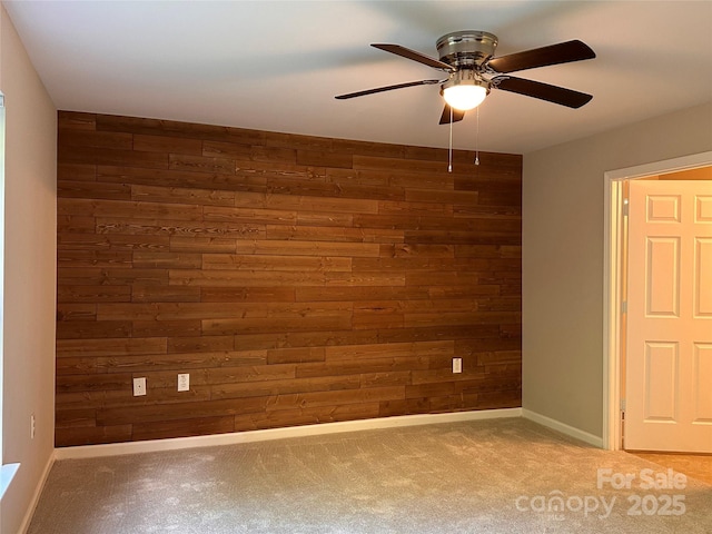 5236 Hilltop Rd, Jamestown, NC 27282 - spare room with wood walls, ceiling fan, and carpet flooring