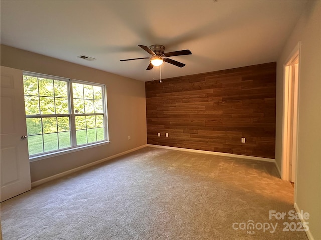 5236 Hilltop Rd, Jamestown, NC 27282 - carpeted empty room with wooden walls and a ceiling fan