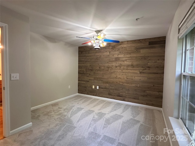 5236 Hilltop Rd, Jamestown, NC 27282 - empty room featuring wooden walls, a ceiling fan, and carpet