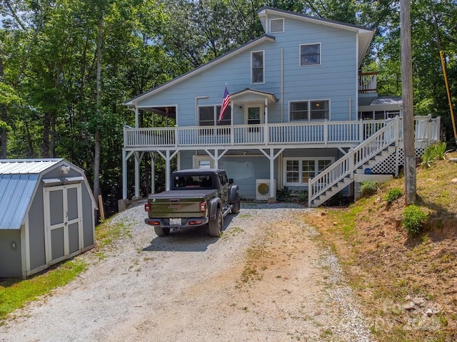 155 Notta Rd, Franklin, NC 28734 - view of front of property with dirt driveway, a storage unit, stairs, a deck, and a garage