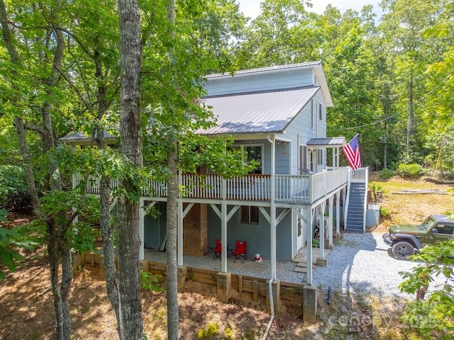 155 Notta Rd, Franklin, NC 28734 - back of property featuring a wooden deck, stairs, a metal roof, and a patio area
