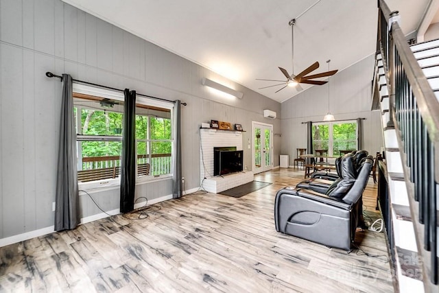 155 Notta Rd, Franklin, NC 28734 - living area featuring ceiling fan, wood finished floors, a brick fireplace, stairway, and high vaulted ceiling