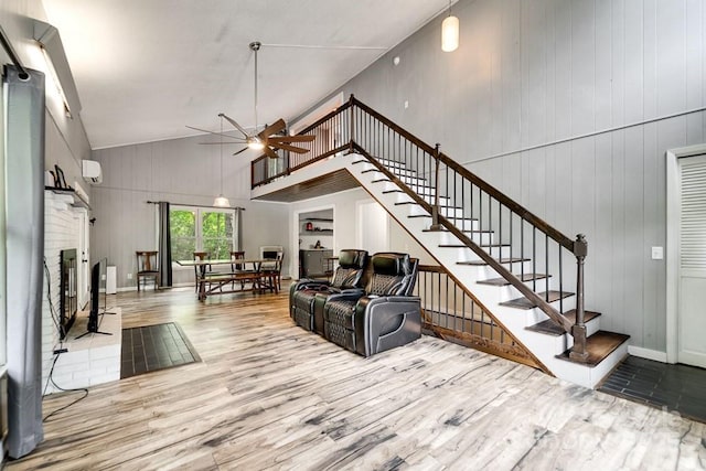 155 Notta Rd, Franklin, NC 28734 - living area featuring a ceiling fan, wood finished floors, stairway, high vaulted ceiling, and a fireplace