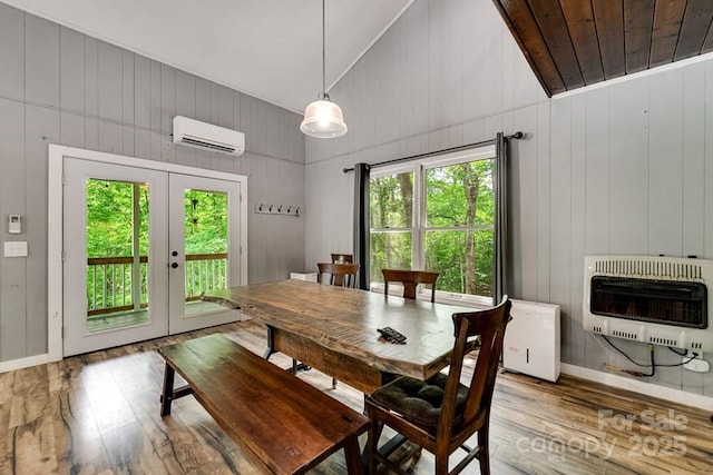 155 Notta Rd, Franklin, NC 28734 - dining area with heating unit, an AC wall unit, hardwood / wood-style flooring, french doors, and wooden walls