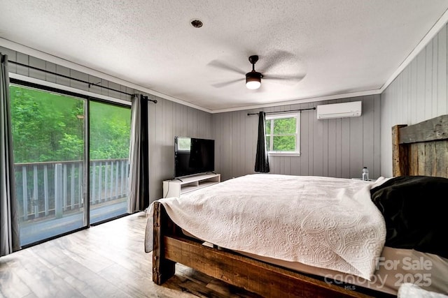155 Notta Rd, Franklin, NC 28734 - bedroom featuring a textured ceiling, access to outside, wood finished floors, crown molding, and an AC wall unit