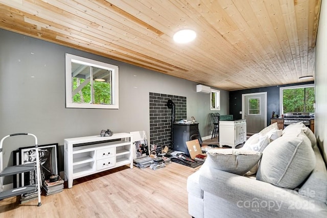 155 Notta Rd, Franklin, NC 28734 - living area with a wall unit AC, wood ceiling, a wood stove, and light wood-style floors