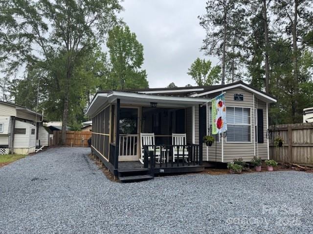 103 Holly Harbor Trl Unit 348A, Mount Gilead, NC 27306 - view of front of house featuring driveway and a sunroom