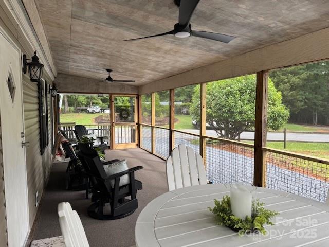 103 Holly Harbor Trl Unit 348A, Mount Gilead, NC 27306 - sunroom with a ceiling fan and outdoor dining space