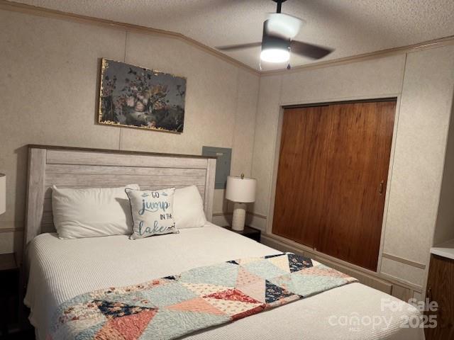 103 Holly Harbor Trl Unit 348A, Mount Gilead, NC 27306 - bedroom featuring ornamental molding, a textured ceiling, ceiling fan, a closet, and vaulted ceiling