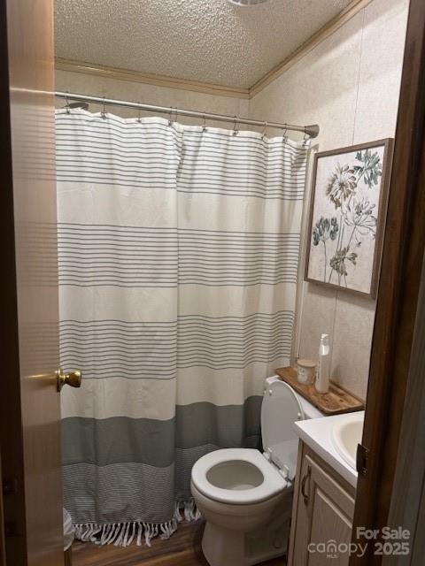 103 Holly Harbor Trl Unit 348A, Mount Gilead, NC 27306 - full bathroom with a textured ceiling, vanity, crown molding, wood finished floors, and a shower with shower curtain