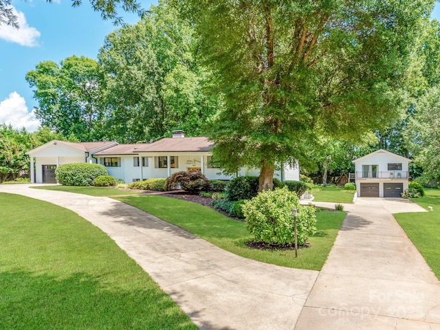 607 W School St, Maiden, NC 28650 - view of front of home with driveway, a front yard, a chimney, and a garage