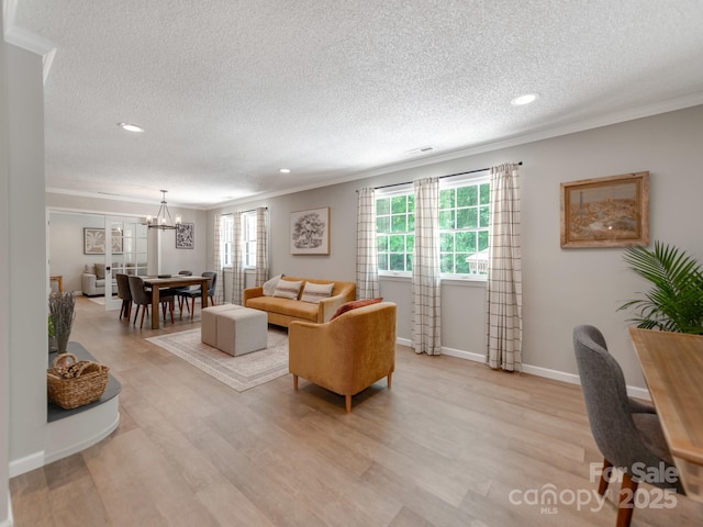 607 W School St, Maiden, NC 28650 - living area with ornamental molding, a chandelier, a textured ceiling, light wood finished floors, and recessed lighting