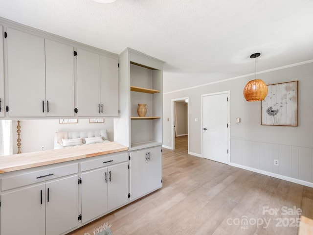 607 W School St, Maiden, NC 28650 - kitchen with open shelves, light countertops, light wood finished floors, and decorative light fixtures