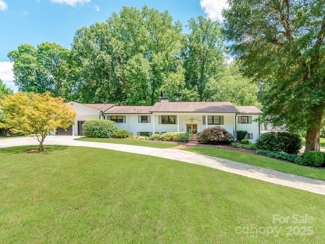 607 W School St, Maiden, NC 28650 - view of front of property featuring french doors, concrete driveway, a front lawn, a chimney, and stucco siding