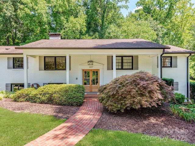 607 W School St, Maiden, NC 28650 - view of front of house with brick siding, a porch, french doors, and roof with shingles