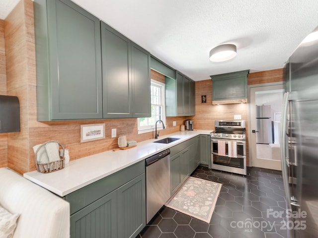 607 W School St, Maiden, NC 28650 - kitchen featuring appliances with stainless steel finishes, tasteful backsplash, light countertops, dark tile patterned floors, and a textured ceiling