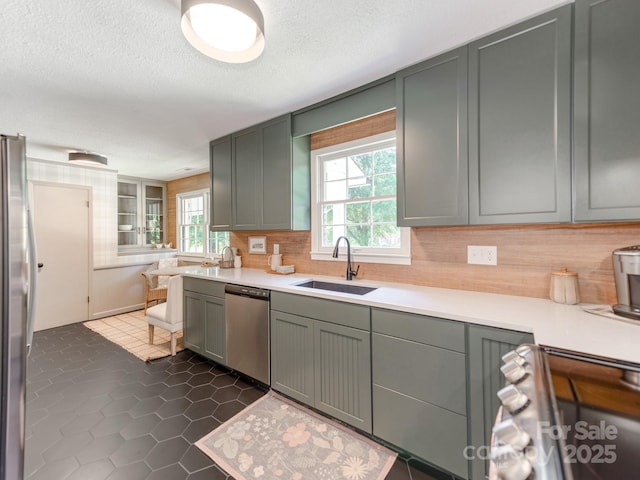 607 W School St, Maiden, NC 28650 - kitchen featuring backsplash, light countertops, appliances with stainless steel finishes, dark tile patterned floors, and a textured ceiling