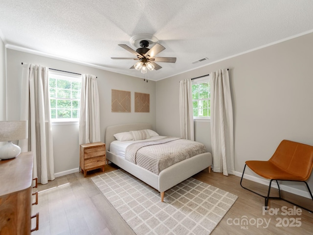 607 W School St, Maiden, NC 28650 - bedroom with a textured ceiling, light wood-style flooring, and ceiling fan