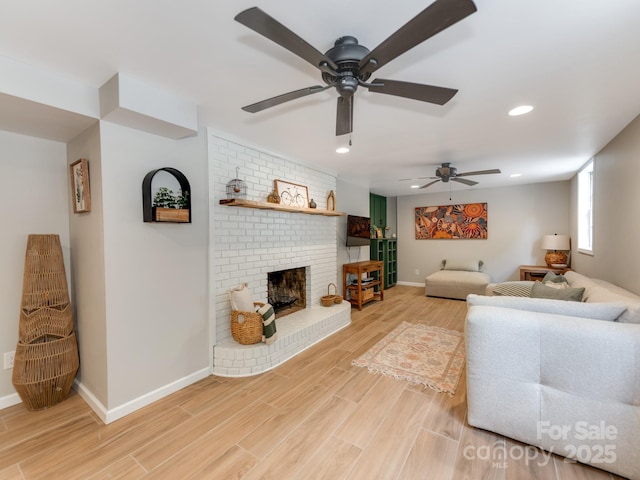 607 W School St, Maiden, NC 28650 - living room featuring a ceiling fan, light wood-style flooring, recessed lighting, and a fireplace