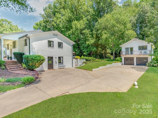 607 W School St, Maiden, NC 28650 - view of side of home with a lawn, brick siding, concrete driveway, and an attached garage