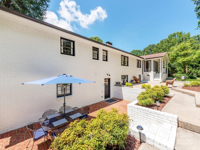 607 W School St, Maiden, NC 28650 - back of property featuring a patio, brick siding, and a chimney
