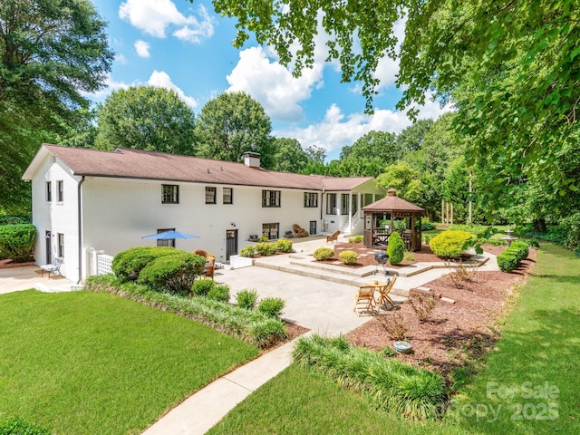 607 W School St, Maiden, NC 28650 - back of house featuring a gazebo, a patio area, a yard, a chimney, and view of wooded area