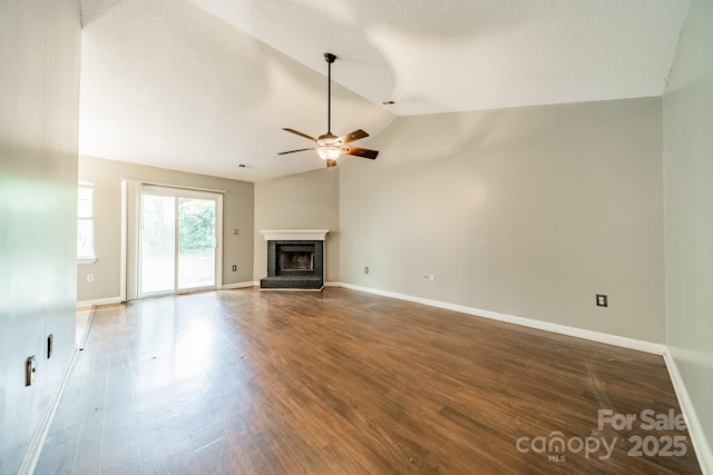 8027 Sherington Way, Charlotte, NC 28227 - unfurnished living room featuring a ceiling fan, lofted ceiling, a brick fireplace, wood finished floors, and a textured ceiling