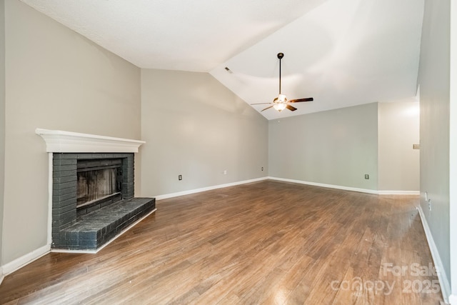 8027 Sherington Way, Charlotte, NC 28227 - unfurnished living room featuring a ceiling fan, a fireplace, vaulted ceiling, and wood finished floors