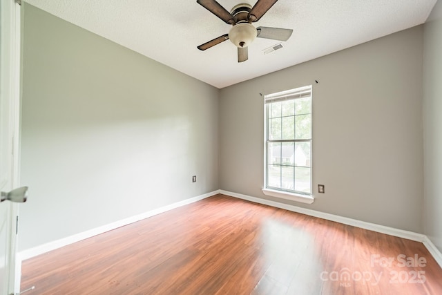 8027 Sherington Way, Charlotte, NC 28227 - empty room with wood finished floors and a ceiling fan