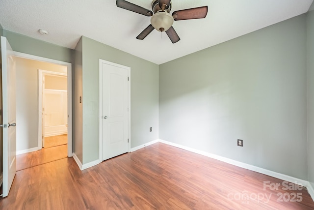8027 Sherington Way, Charlotte, NC 28227 - unfurnished bedroom with wood finished floors and a ceiling fan