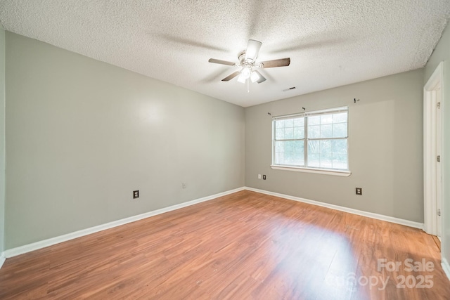 8027 Sherington Way, Charlotte, NC 28227 - spare room with light wood-style floors, a ceiling fan, and a textured ceiling