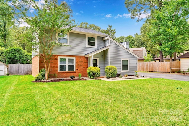 15804 Fairfield Dr, Matthews, NC 28104 - view of front of house with a chimney, a storage shed, and brick siding