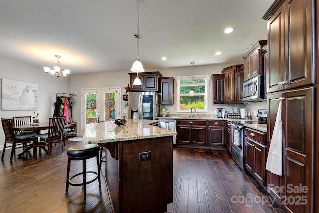 266 Egret Ln, Sylva, NC 28779 - kitchen with appliances with stainless steel finishes, a kitchen island, recessed lighting, a kitchen breakfast bar, and decorative light fixtures