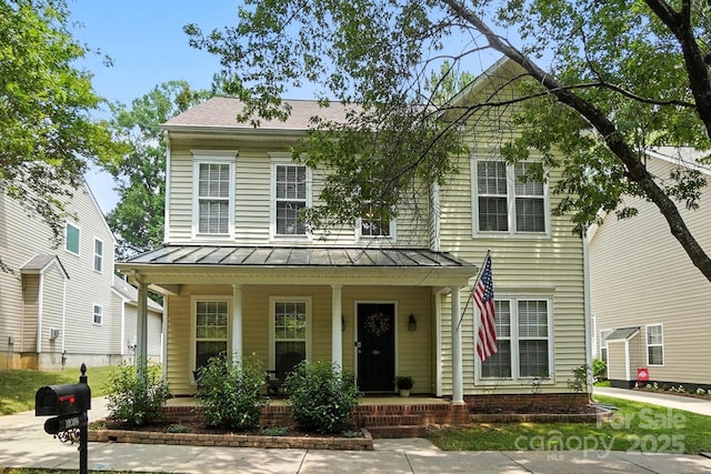 10306 Meadow Crossing Ln, Cornelius, NC 28031 - view of front of house with a porch, a standing seam roof, and a metal roof