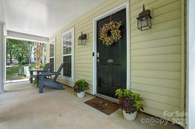 10306 Meadow Crossing Ln, Cornelius, NC 28031 - doorway to property featuring covered porch
