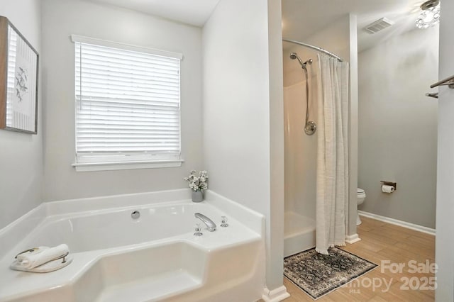 10306 Meadow Crossing Ln, Cornelius, NC 28031 - bathroom featuring a garden tub, a shower with curtain, and wood finished floors