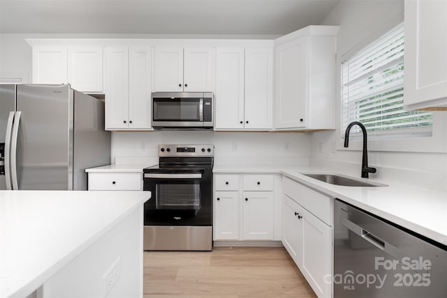 794 Stanley Spencer Mtn Rd, Gastonia, NC 28056 - kitchen with appliances with stainless steel finishes, light countertops, and white cabinets