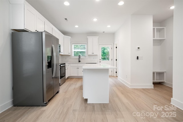 794 Stanley Spencer Mtn Rd, Gastonia, NC 28056 - kitchen with appliances with stainless steel finishes, white cabinetry, light countertops, a kitchen island, and recessed lighting