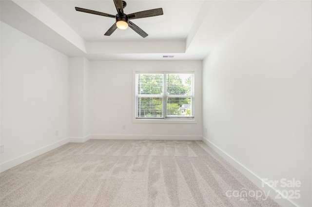 794 Stanley Spencer Mtn Rd, Gastonia, NC 28056 - empty room featuring a tray ceiling, light colored carpet, and ceiling fan