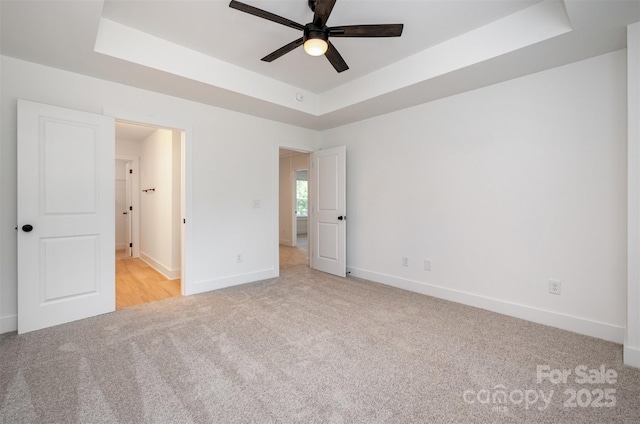 794 Stanley Spencer Mtn Rd, Gastonia, NC 28056 - unfurnished bedroom with a tray ceiling and light colored carpet
