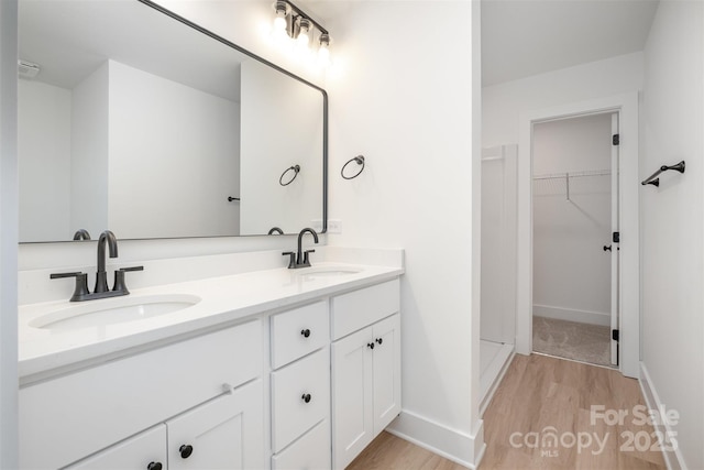 794 Stanley Spencer Mtn Rd, Gastonia, NC 28056 - full bathroom featuring wood finished floors, double vanity, and a spacious closet