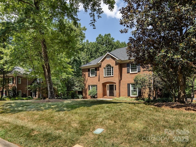 9413 Tillot Dr, Matthews, NC 28105 - colonial-style house with a front lawn and brick siding