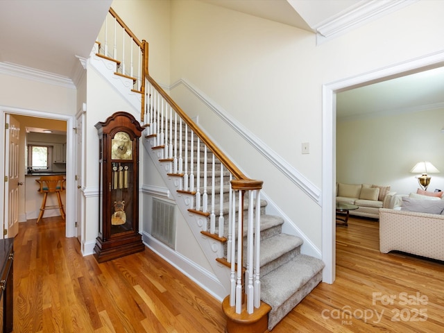 9413 Tillot Dr, Matthews, NC 28105 - stairway featuring ornamental molding and wood finished floors