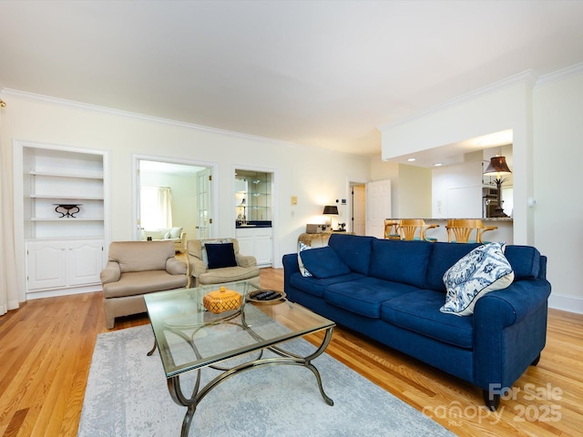 9413 Tillot Dr, Matthews, NC 28105 - living area with ornamental molding, light wood-style floors, and built in shelves