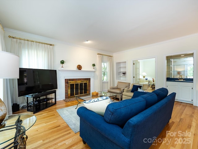 9413 Tillot Dr, Matthews, NC 28105 - living area with crown molding, light wood finished floors, a brick fireplace, and built in features