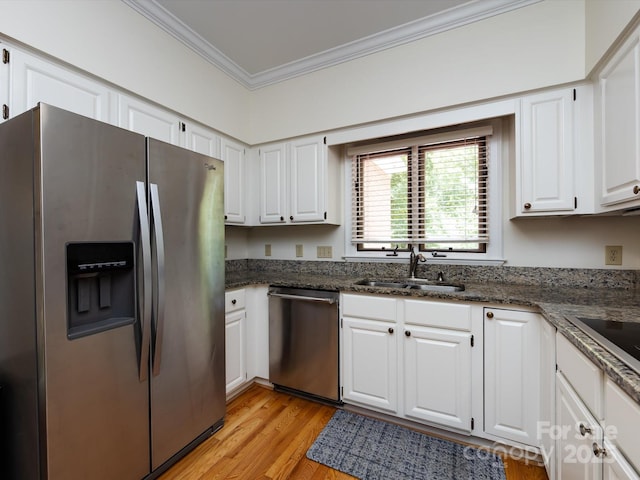 9413 Tillot Dr, Matthews, NC 28105 - kitchen featuring appliances with stainless steel finishes, ornamental molding, white cabinetry, light wood-style floors, and dark stone counters